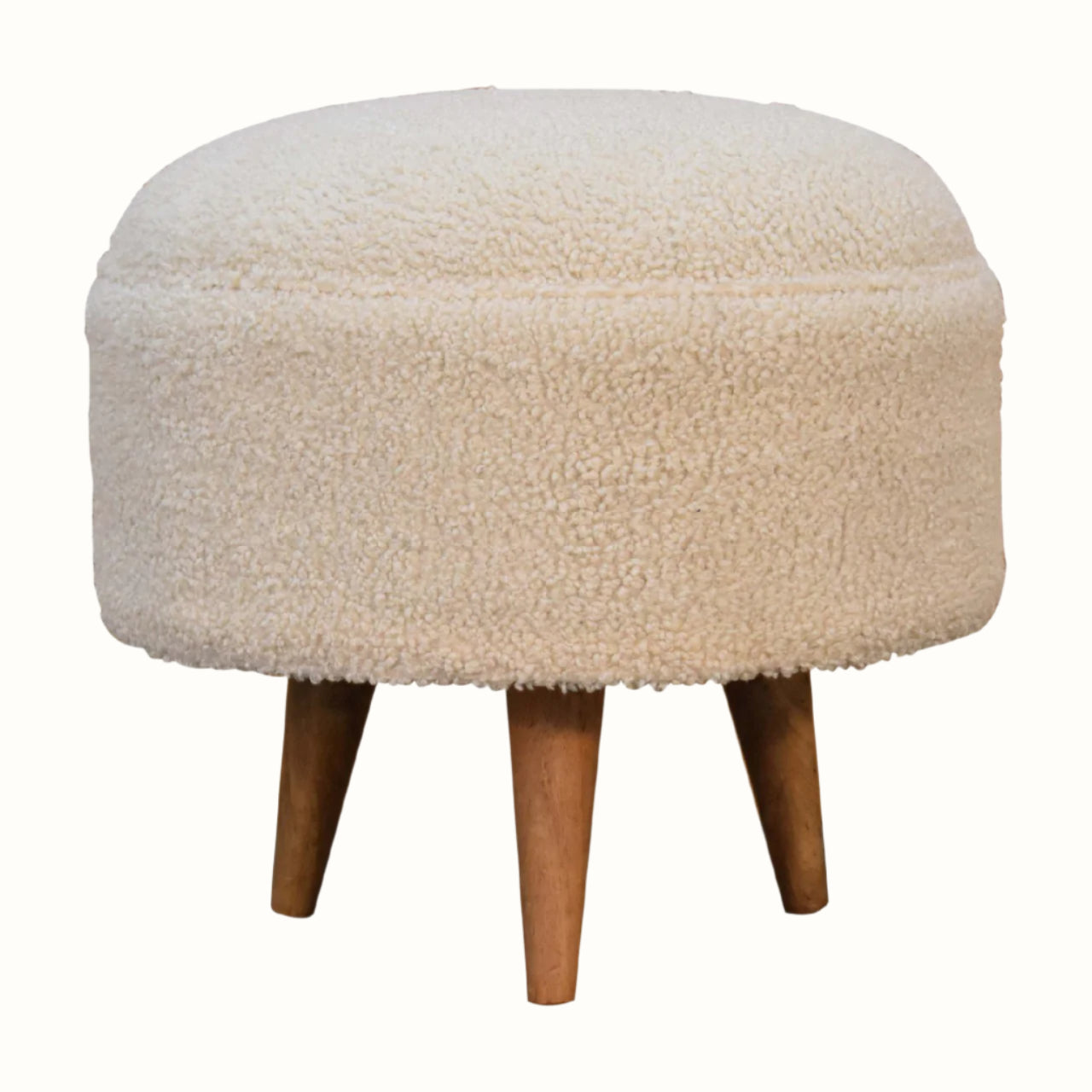 Circular footstool upholstered in cream fabric, Scandinavian style.