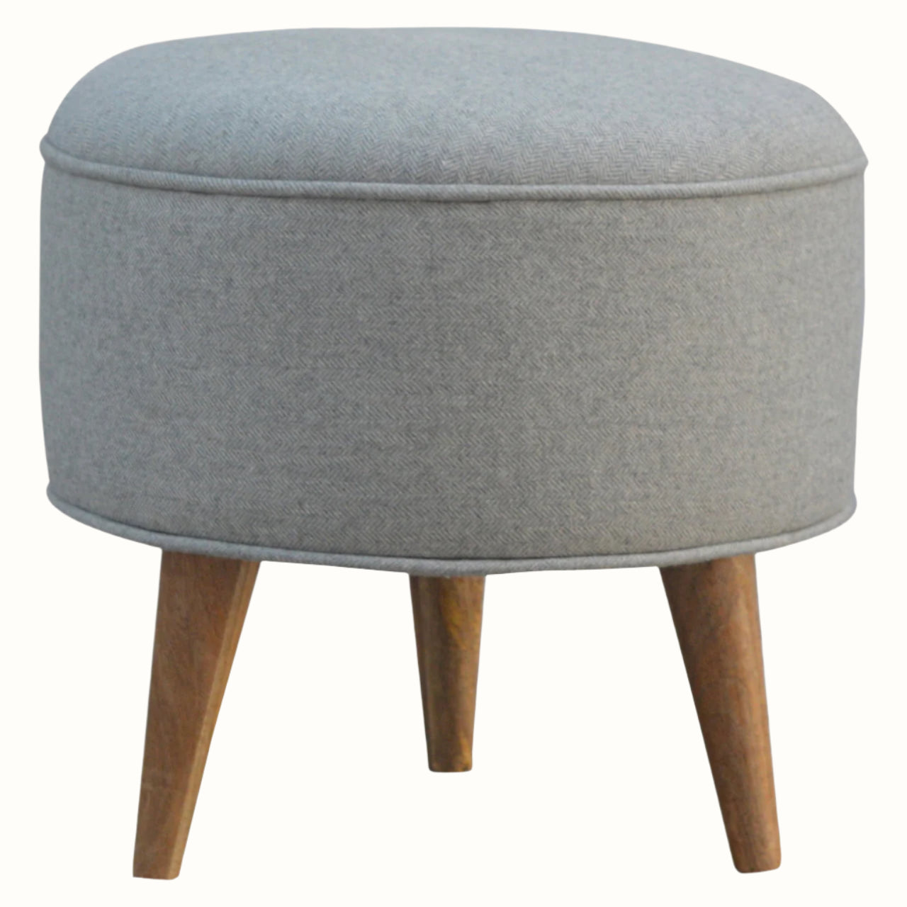 Nordic round footstool upholstered in grey tweed, with light wood legs.