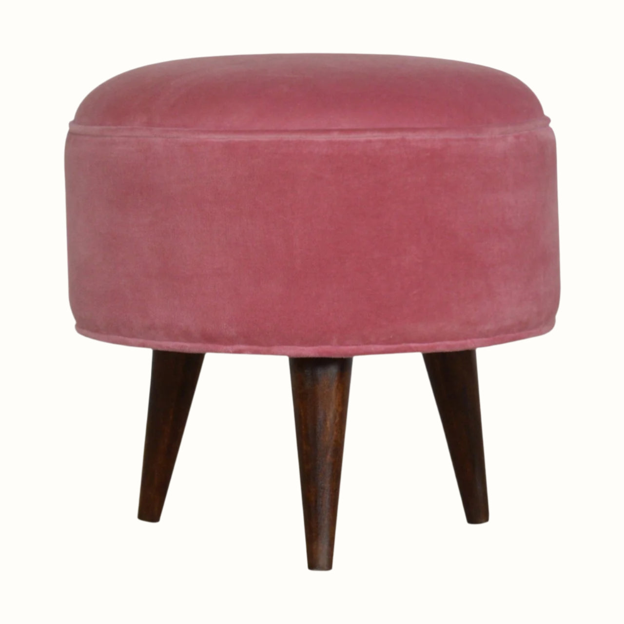 Round footstool upholstered in pink velvet.