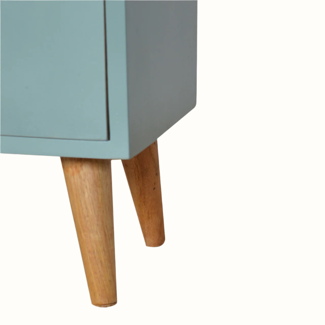 Close-up of a light blue cabinet with wooden legs on a white background
