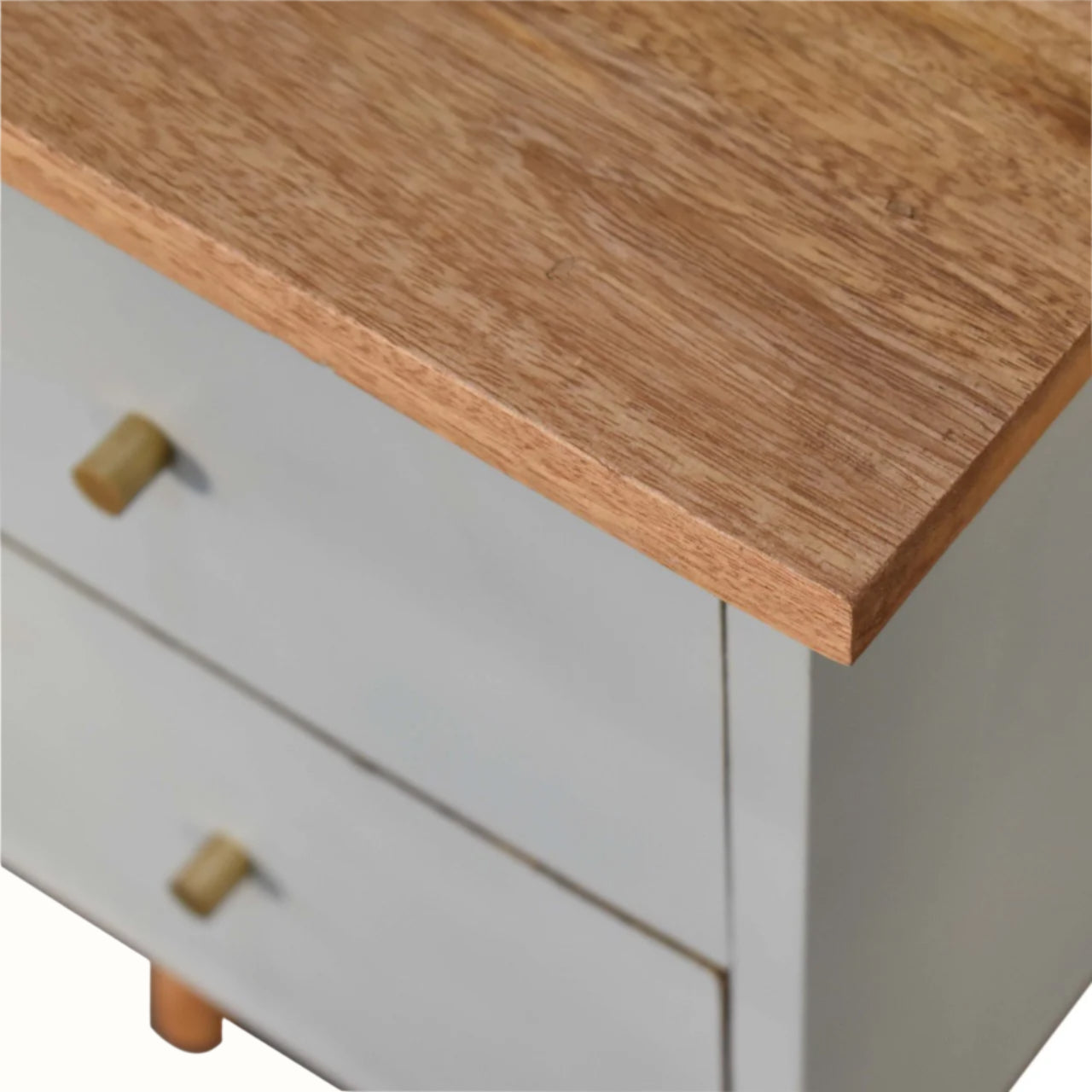 Wooden countertop on a white cabinet with a blurred background