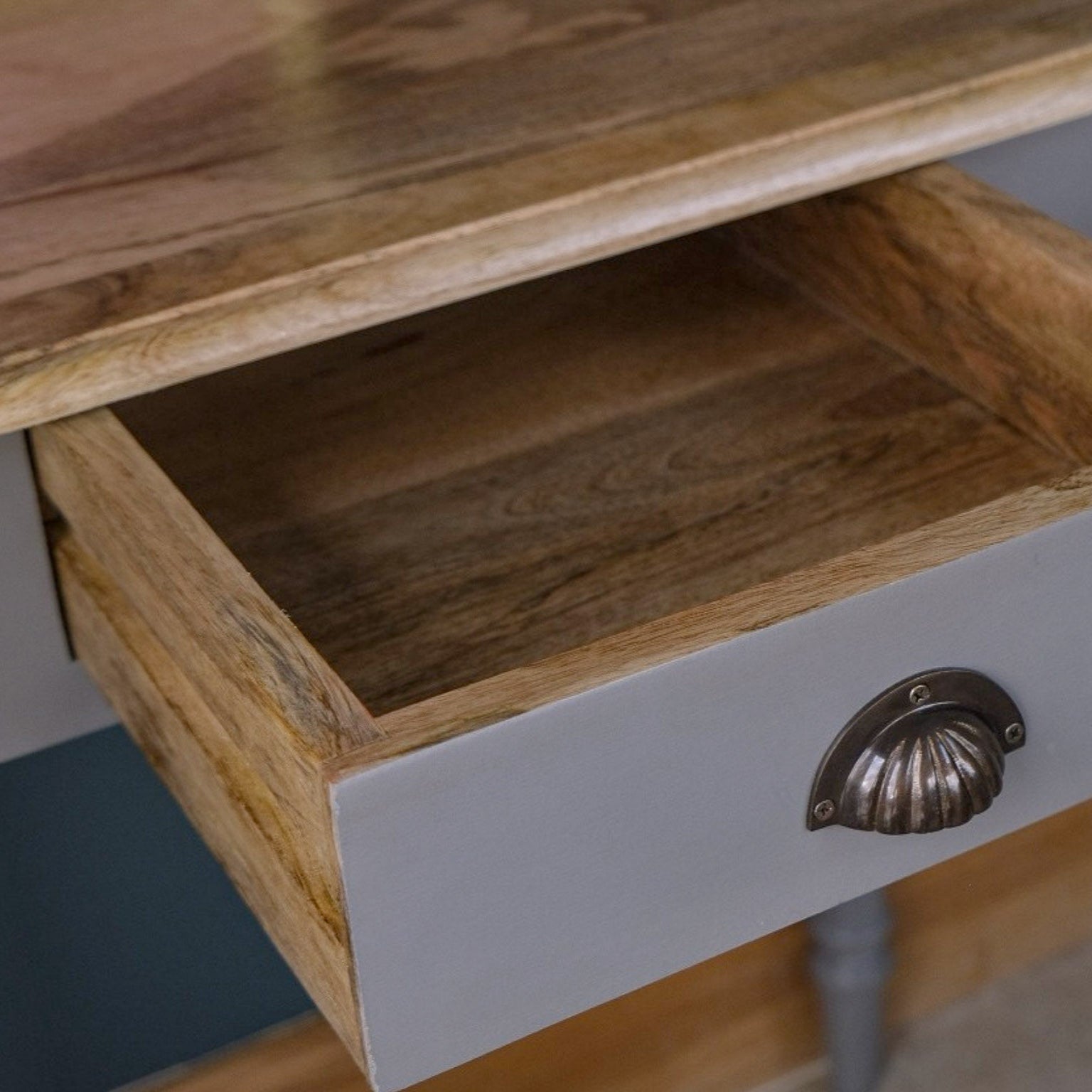 Solid wood desk drawer open.