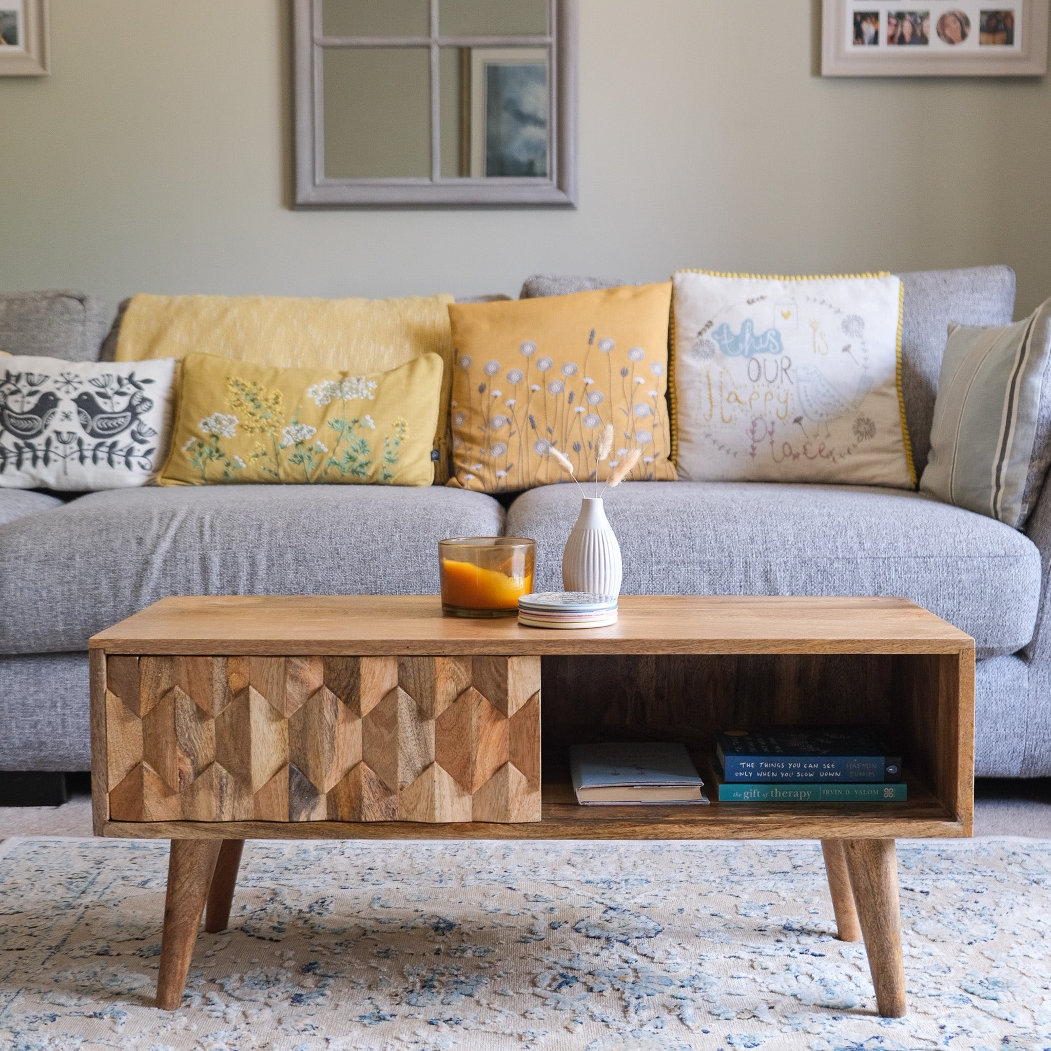 Living room featuring solid wood coffee table with storage in brown stain.