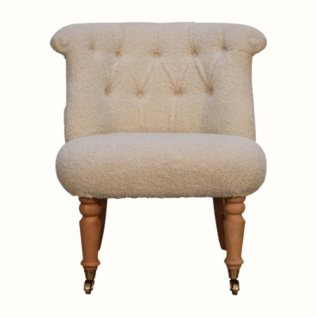Vintage style accent chair in a cream boucle fabric.