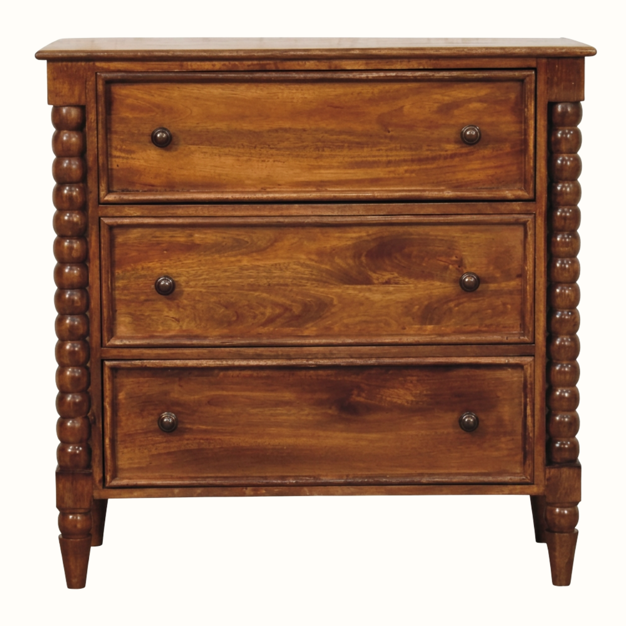 A three-drawer wooden chest of drawers with turned spindle legs and small round dark knobs, shown against a plain white background.