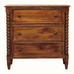 A three-drawer wooden chest of drawers with turned spindle legs and small round dark knobs, shown against a plain white background.