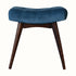 Curved bench upholstered in blue velvet, with dark wood legs.