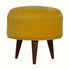 Round wooden footstool upholstered in yellow velvet. 