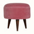Round footstool upholstered in pink velvet. 