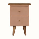 Handpainted bedside table made from solid wood, in a blush pink finish. Bedside features 2 drawers with brass hardware, and four short tapered legs.