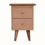 Handpainted bedside table made from solid wood, in a blush pink finish. Bedside features 2 drawers with brass hardware, and four short tapered legs.