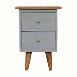 Small cabinet with two drawers and a wooden top on a white background