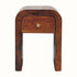 Rounded mango wood bedside table in a dark brown finish. 