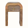 Small curved bedside table made from mango wood in a light brown finish.