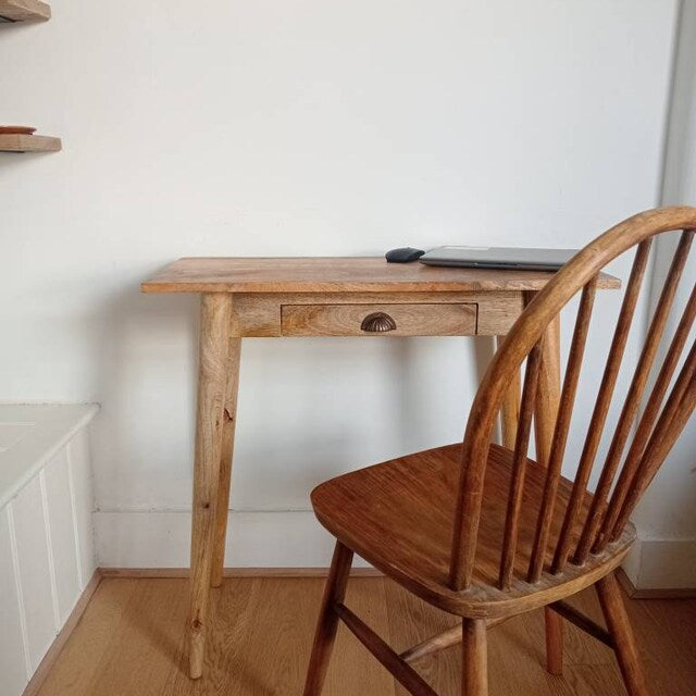 Small mango wood desk with a chair in a minimalistic room