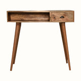 Desk crafted from solid mango wood in a light brown natural finish, with brass shell handle, one storage drawer and an open slot shelf. 