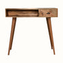 Desk crafted from solid mango wood in a light brown natural finish, with brass shell handle, one storage drawer and an open slot shelf. 