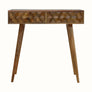 A natural finish mango wood console table with a textured cube-carved design, featuring two drawers and four Nordic-style legs with brass knob detailing.