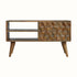 A natural finish mango wood media unit with a textured cube-carved design, featuring two drawers and two open slot shelves, supported by four Nordic-style legs and with brass knob detailing.