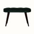 A emerald green velvet bench with walnut wooden legs, featuring deep button detailing.