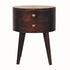 Petite circular bedside table, with two drawers, tapered legs and crafted from solid wood in a brown california walnut finish.