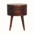 Small circular bedside table, with 2 storage drawers and crafted from mango wood in a dark brown chestnut finish.