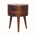 Petite, curved bedside table with two drawers, tripod legs, crafted from mango wood in a dark brown chestnut finish.