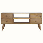 A natural wood TV stand with four drawers and two open slot shelves, featuring brass knobs and short tapered legs.