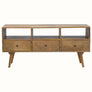 A natural wood TV stand with three drawers and open slots, featuring a traditional Norwegian design.