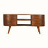 A vintage-style media unit with a chestnut finish, featuring a curved silhouette, brass knobs, and four drawers with open slot shelves on top.
