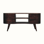 A walnut brown media unit with a curved silhouette, featuring two open slot shelves and four drawers with brass knobs.