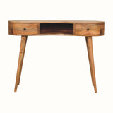 A large, natural finish mango wood writing desk with an open slot shelf and two drawers, featuring a brass knob and four tapered legs.
