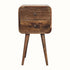 A small bedside table with four legs, made of mango wood with a grey wash finish, featuring two drawers with brass knobs.