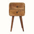 A small natural wood bedside table with two drawers and four Nordic-style legs.