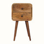 A small natural wood bedside table with two drawers and four Nordic-style legs.