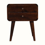 Curved bedside table, in dark wood finish, with two drawers, brass hardware and tapered legs.