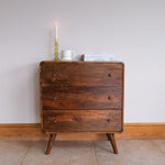 Rounded wooden chest of 3 drawers in a dark brown stain.