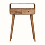 A small natural-finished Hamade open console table with two drawers and brass knobs, featuring long tapered legs.
