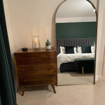 Stylish bedroom featuring a dark wood chest of 3 drawers in a Mid Century Modern style.