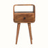A small natural wood bedside table with an open shelf, a drawer, and a brass knob on a white background.