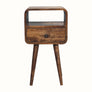 Small bedside table, made from wood in grey wash finish, with open slot shelf, drawer and tapered-style legs.