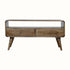 A grey wash finish TV stand with an open shelf and two drawers with brass knobs, featuring a medium-sized flat screen TV.