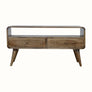 A grey wash finish TV stand with an open shelf and two drawers with brass knobs, featuring a medium-sized flat screen TV.