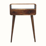 A small console table with a chestnut finish, featuring an open shelf, two drawers, and brass knobs, set on long tapered legs.