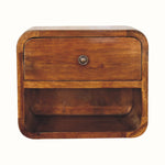 A small chestnut-colored, wall-mounted bedside table with a drawer and an open shelf beneath.