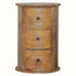 Circular drum chest side table, with 3 small drawers, brass hardware, and mango wood body, in a light brown, natural stain.