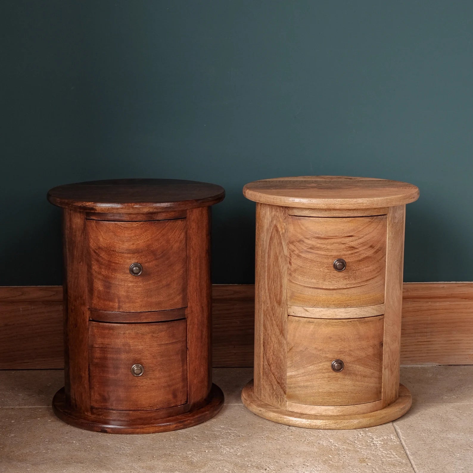 Two round solid wood drum chests with 2 drawers in a light and dark brown stain, both with brass hardware.