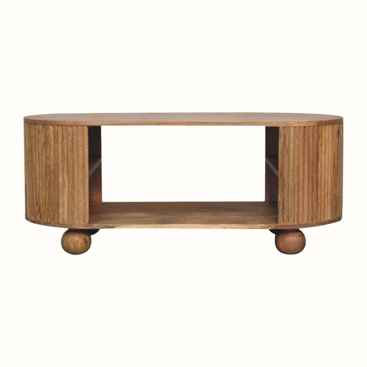 A chunky, curved coffee table, made from mango wood in a light brown finish, with chunky ball feet and a grooved wood pattern.
