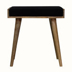 Small square tray-style bench in a black velvet, and a natural wooden body.