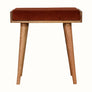 Small square tray-style bench in a brick red velvet, and a natural wooden body.